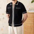 Slim-fit black lapel short-sleeved polo shirt on a hanger, showing collar detail.