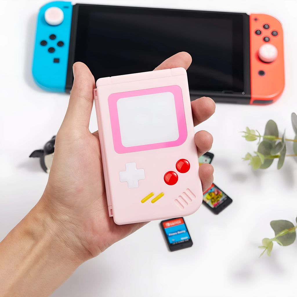 Hard plastic Nintendo Switch game card storage box in blue colour, shown next to game cartridges.