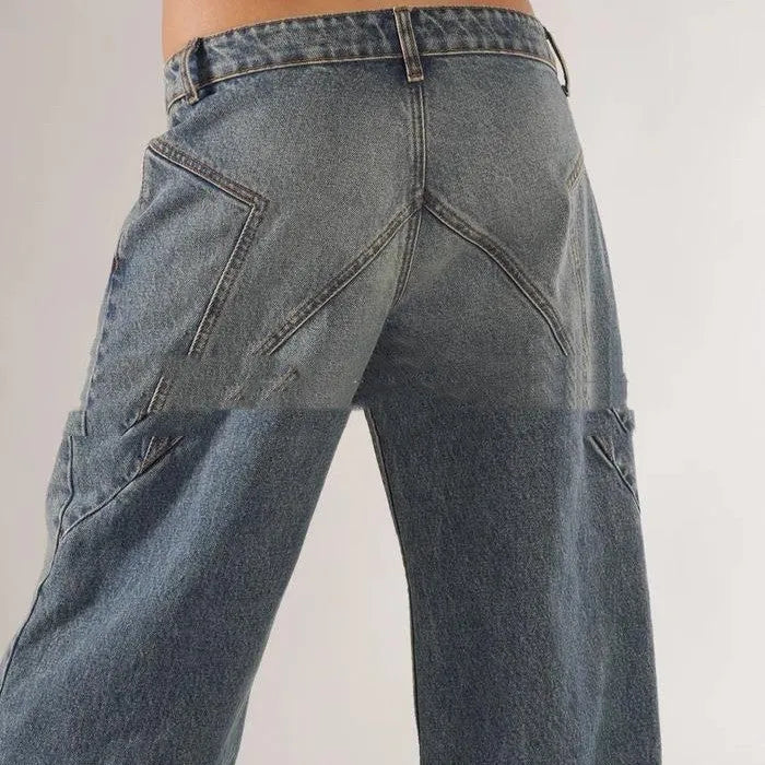 Blue loose straight wide leg cotton trousers with low waist and splicing detail on a hanger.