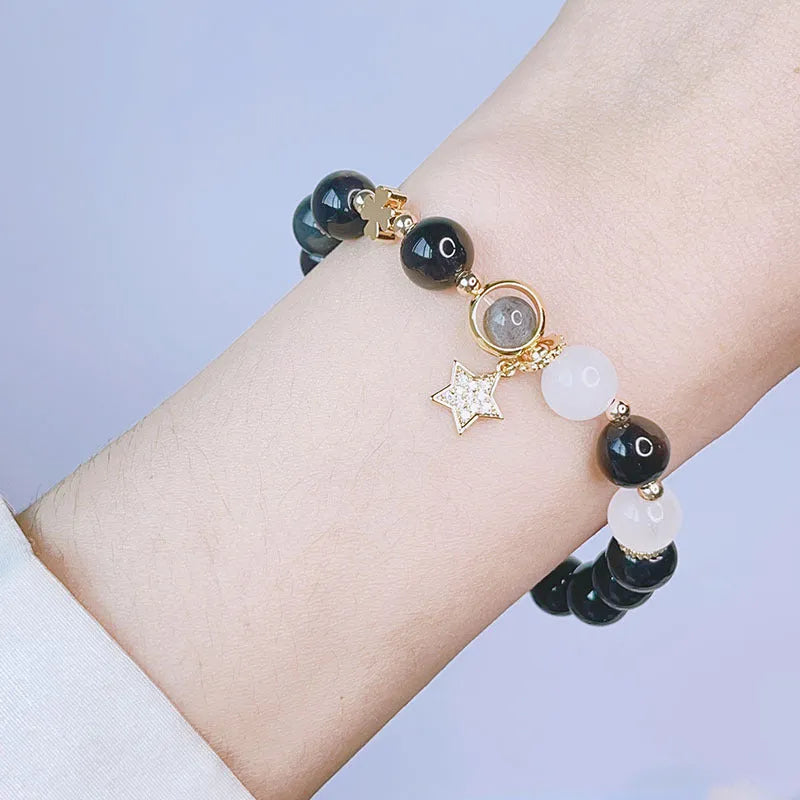 Women's silverstone bracelet with electroplated finish showing floral, love, and star charm designs