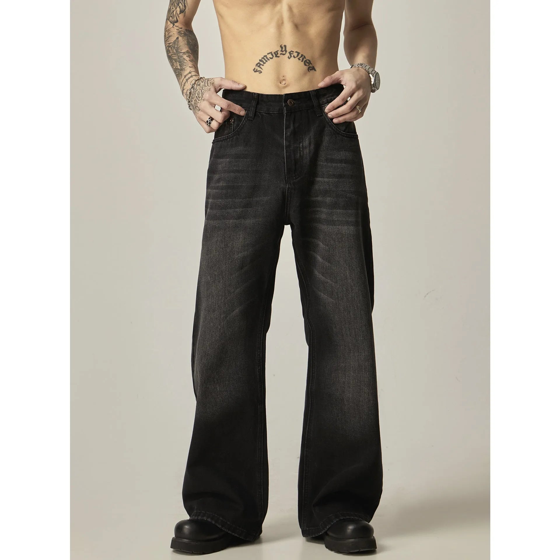Black loose straight jeans with retro styling and zipper fly on mannequin