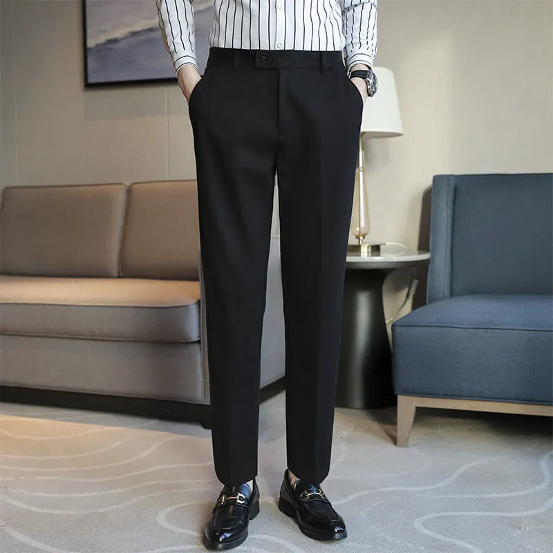 Brown straight leg corduroy trousers for men laid flat, showing slim fit and elastic waistband detail.