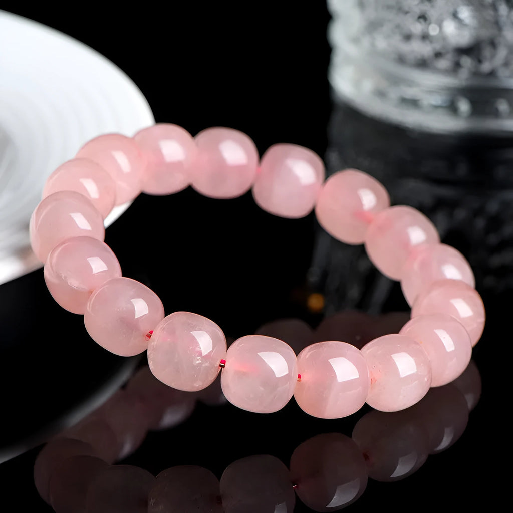 Natural crystal barrel shaped bead bracelet with pink polished geometric beads