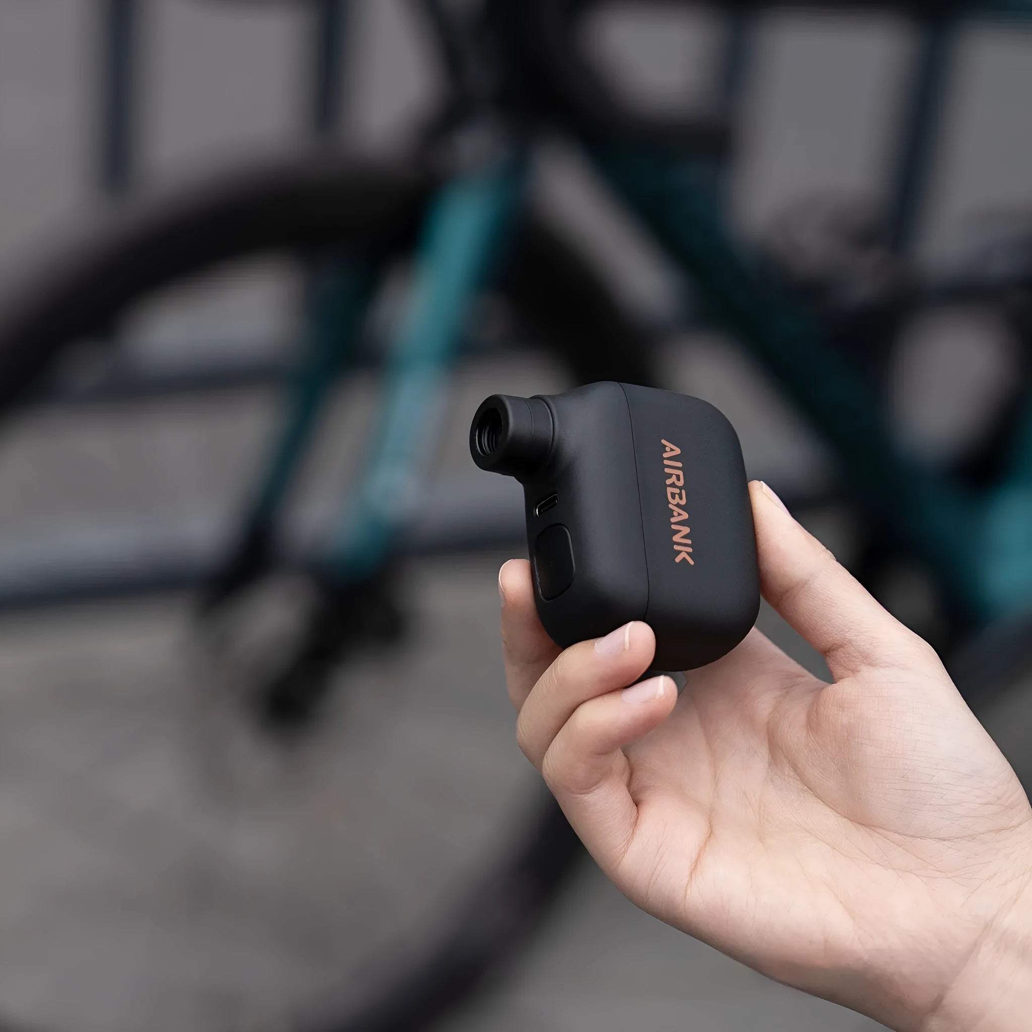 Black plastic USB-rechargeable electric bicycle tyre inflator pump with charging cable and waterproof bag