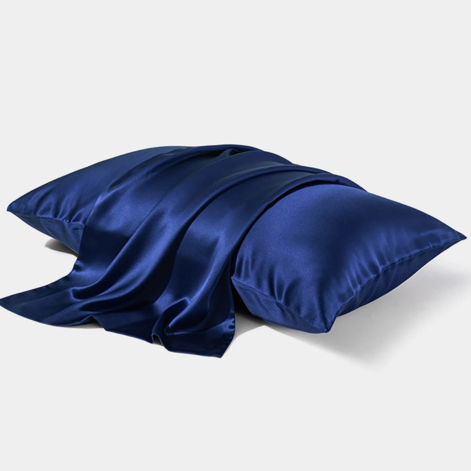 Dark grey 19 momme mulberry silk pillowcase showing envelope closure on a bed.