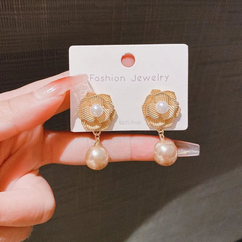 Gold-coloured floral stud earrings with a detailed needle rose pearl and opal stone design.