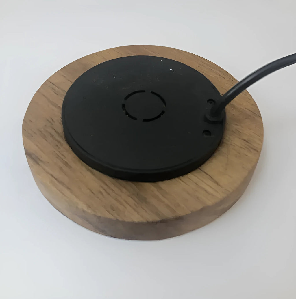 Black round 60mm diameter wireless phone charger for embedding into desk or table surface.