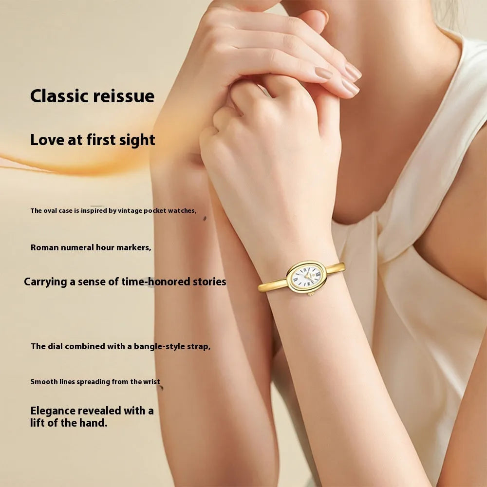 Women's gold and silver oval retro quartz watch with spiral pattern dial options on wrist.