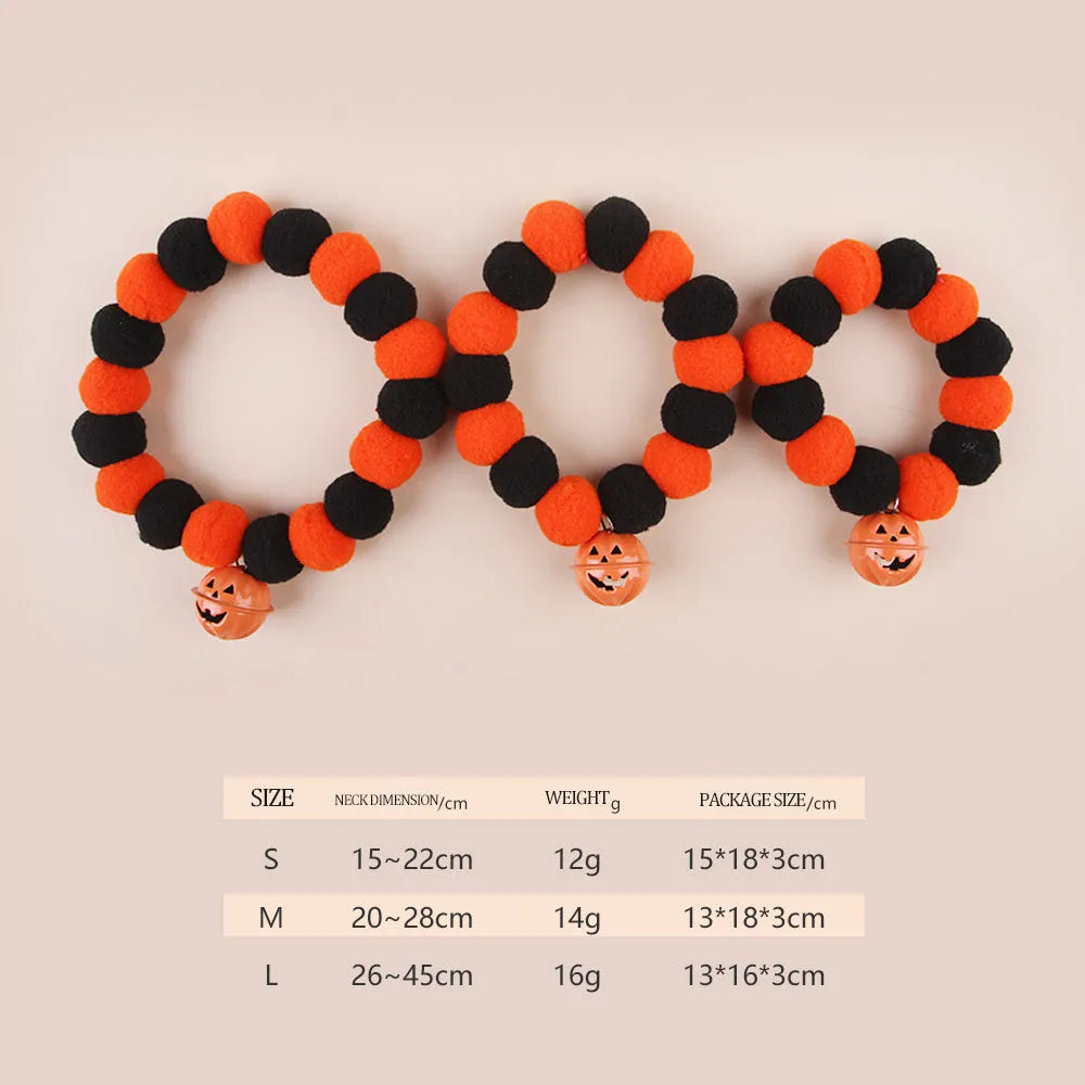 Orange Halloween cat collar with pumpkin print, breakaway buckle, and bell on a fabric band.