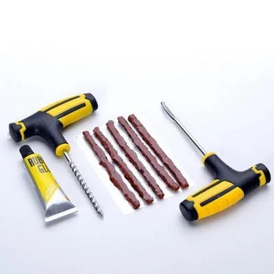 Black and yellow vacuum tyre repair tool set with probe, pin, glue, and rubber strips on plastic packaging.
