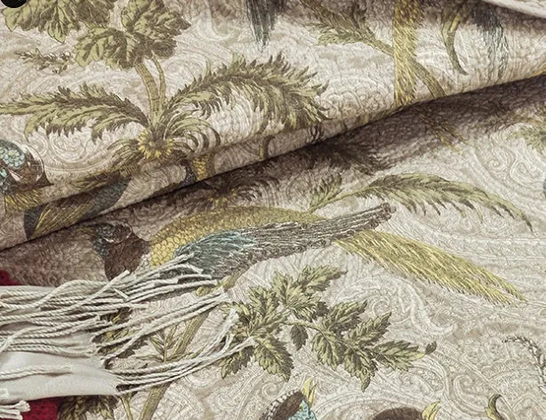 Blue botanical patterned quilted cotton bedspread set on a bed, showing plants, flowers, and bird design.