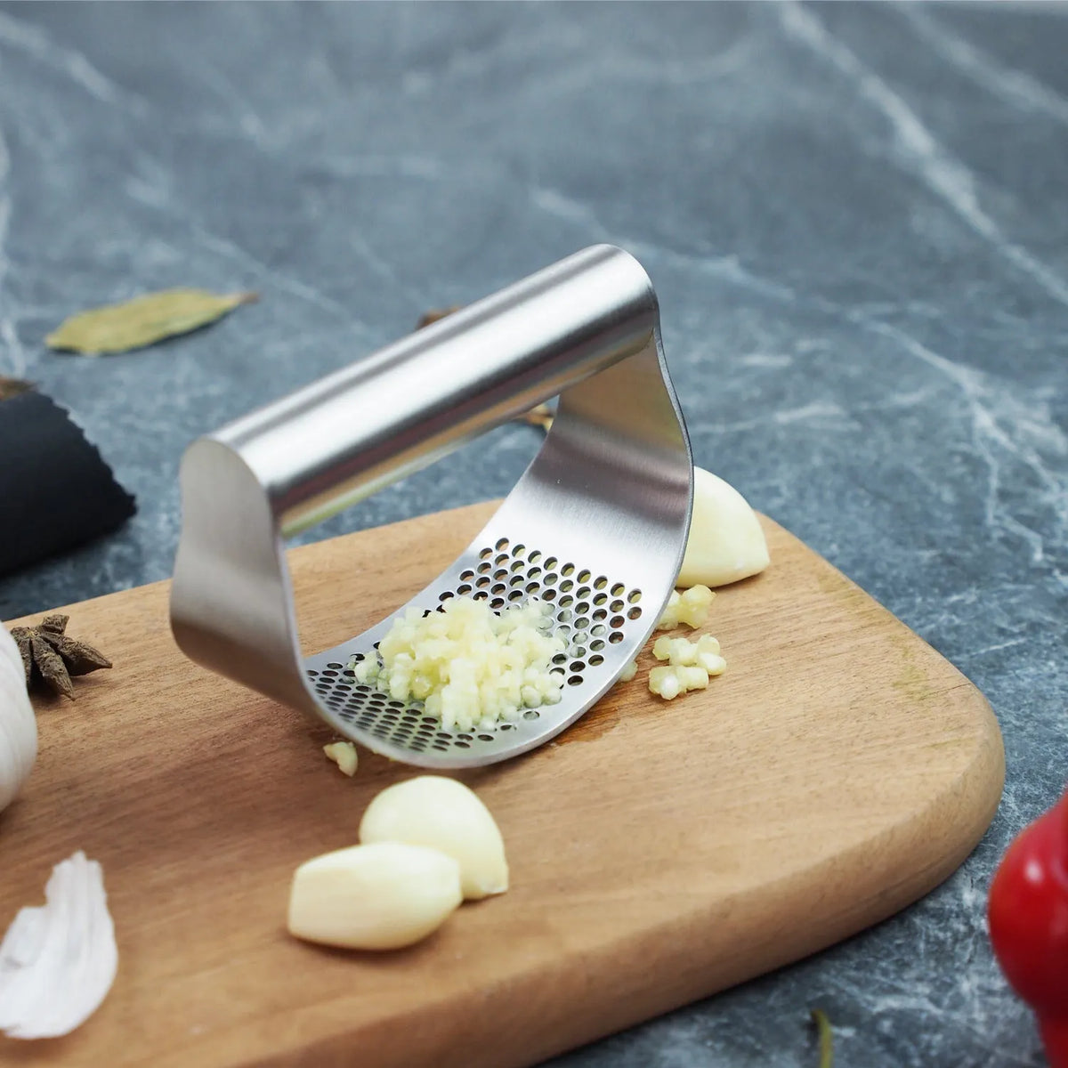 Stainless steel onion fork with PP handle and uniform fine holes for garlic pressing and holding vegetables, potatoes, fish, meat, and onions.