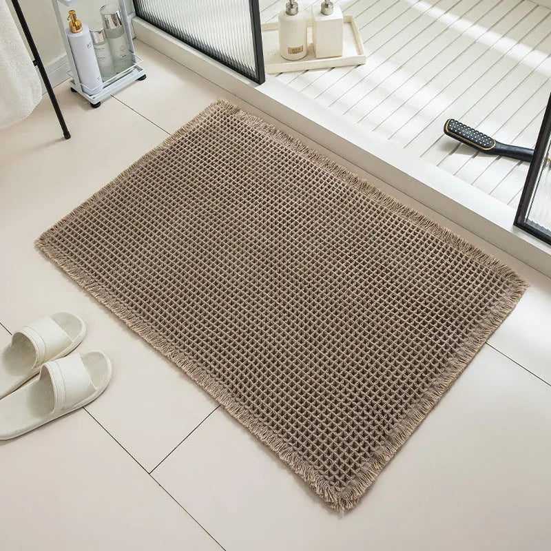 Checkered pattern non-slip absorbent bathroom carpet on a tiled floor.