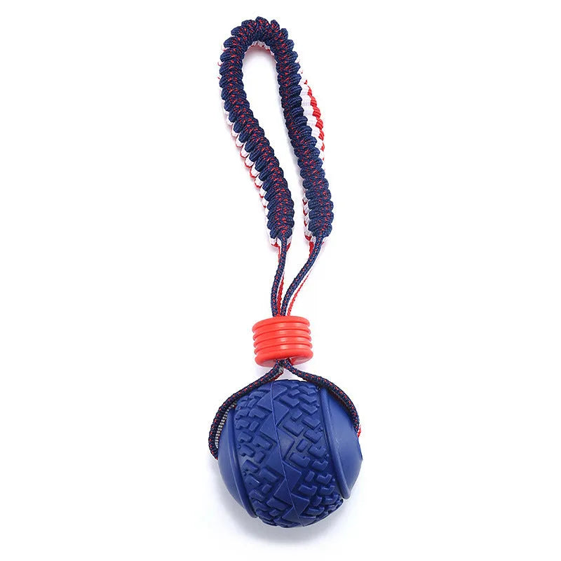 Blue and red natural rubber dog ball with attached rope toy for medium and small breeds.