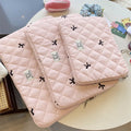 Cute rhombus embroidered bow laptop storage bag in nylon, shown in light pink colour.