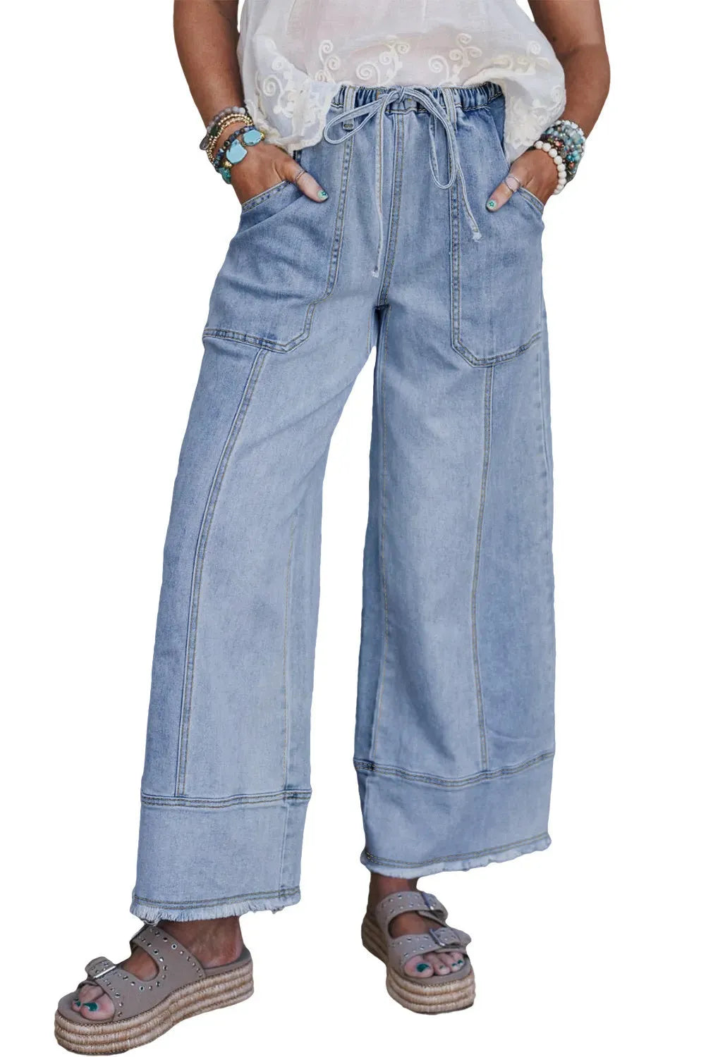 Beau blue wide leg women's denim trousers with a drawstring waist and raw hem detailing.