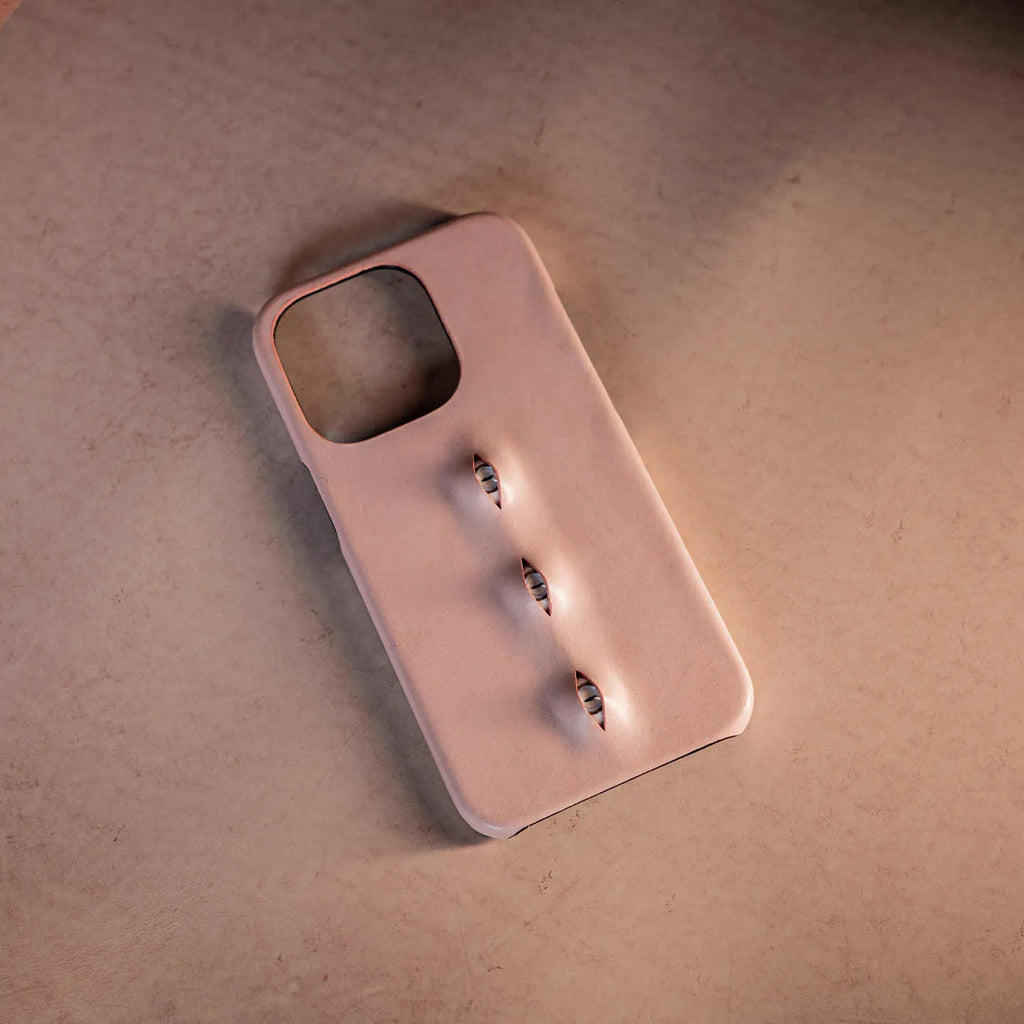 Pink eye-shaped handmade iPhone case in waxed vegetable-tanned cowhide with PC bottom case