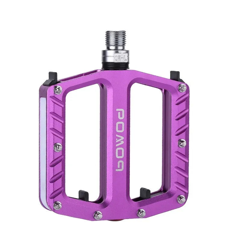 Aluminium alloy bicycle pedals with 710 LED lights in purple, black, titanium, red, and gold colours.