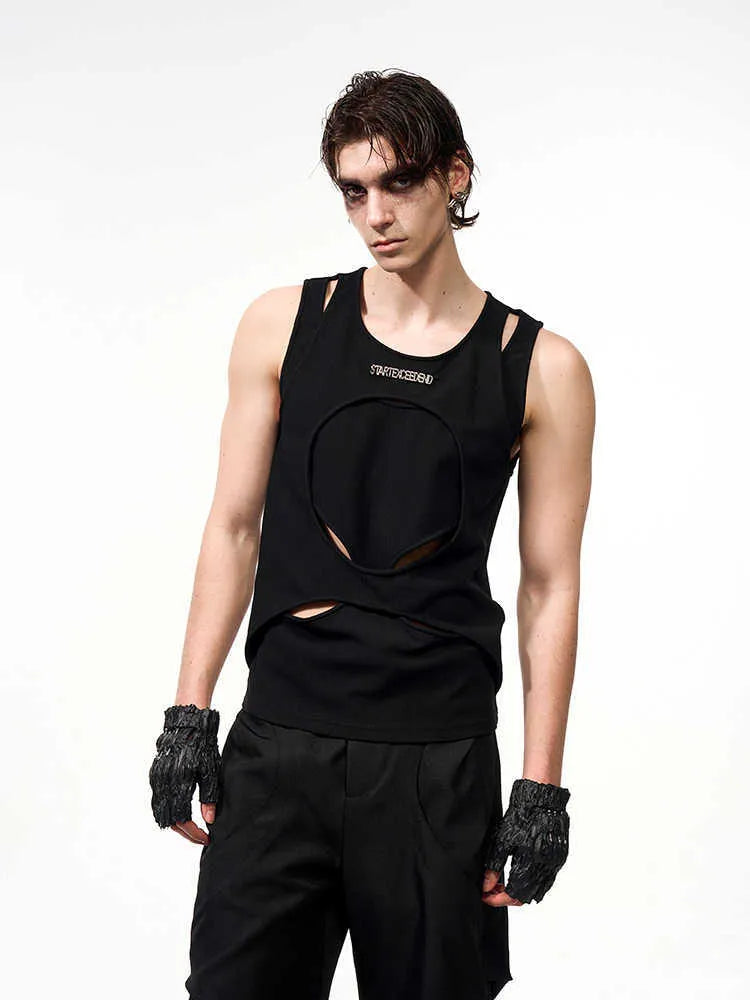 Man wearing a loose-fitting white sleeveless hollow-out thread waistcoat with a round neck.