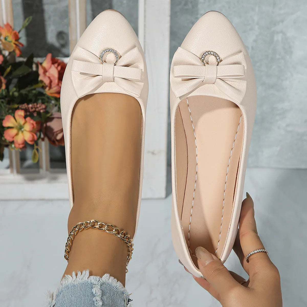 Women's beige casual flat slip-on shoe with a bowknot and round toe on a rubber sole.