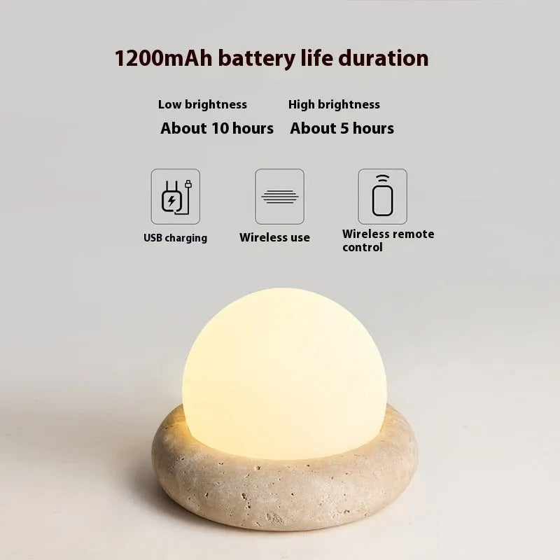 Modern simple bedside night light with remote control on a table.