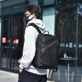 Waterproof PU leather backpack in black with contrast stitching and large capacity design