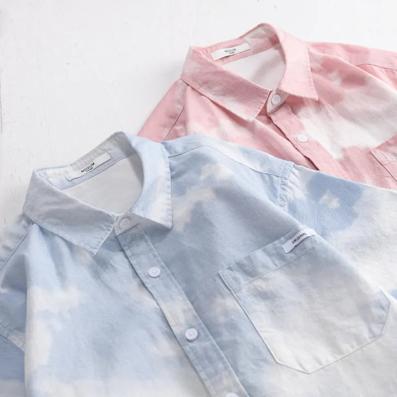 Man wearing a light pink loose-fitting pure cotton short-sleeved cardigan-style shirt.