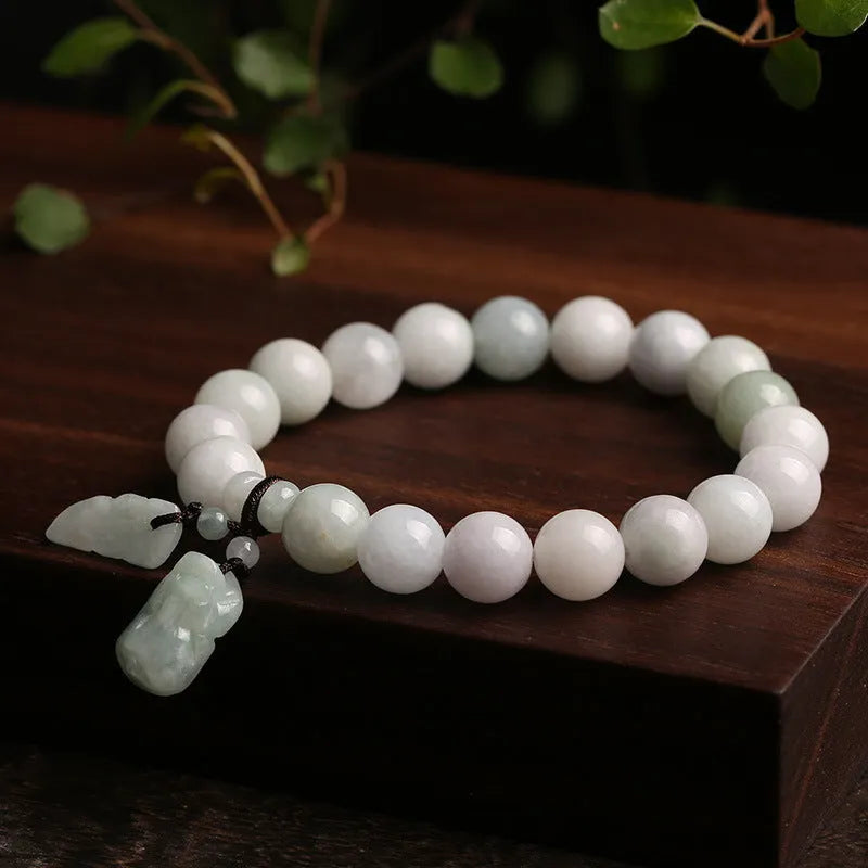 Green jade geometric bracelet with hanging Maitreya Buddha pendant on wrist