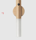 Smart sensor LED desk lamp in solid wood and organic glass with automatic motion activation.
