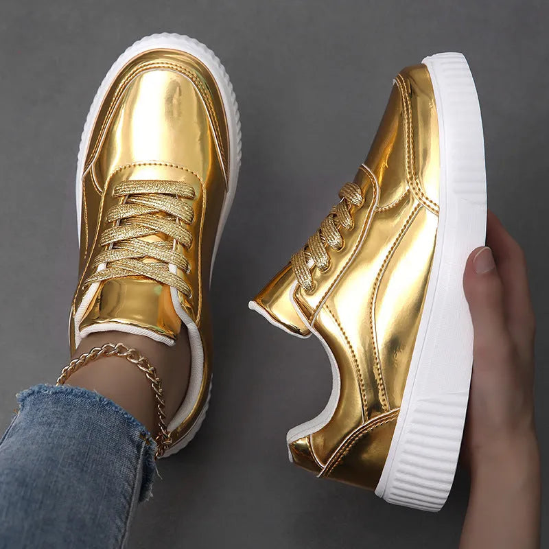 Gold sequinned platform sneaker with round toe and thick MD sole on a white background