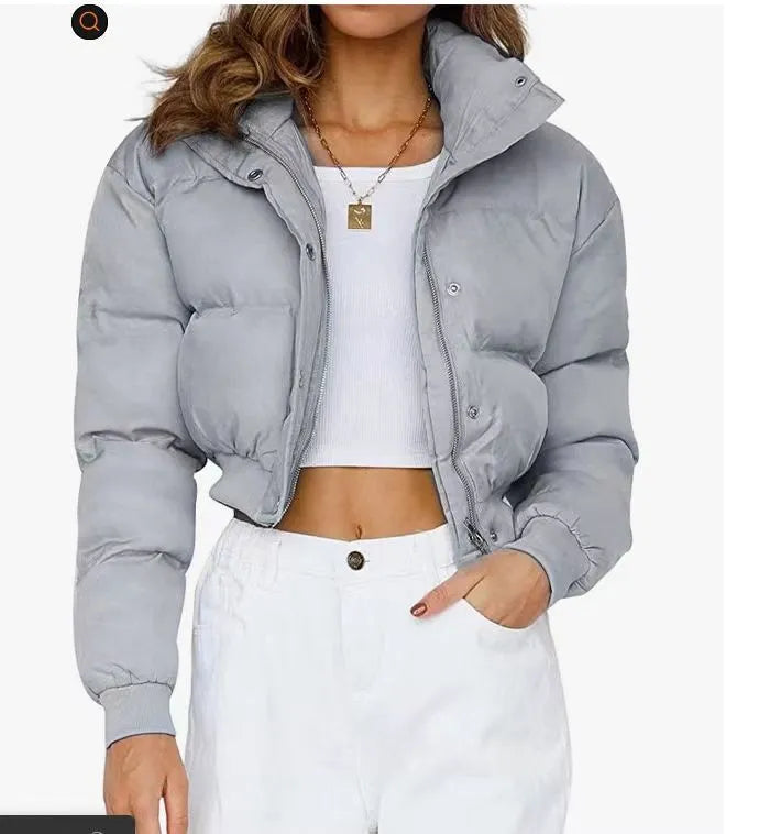 Women's loose-fit blue polyester jacket with long sleeves on a hanger.