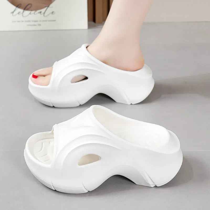 Women's white thick-soled EVA slippers with round toe on a beach background