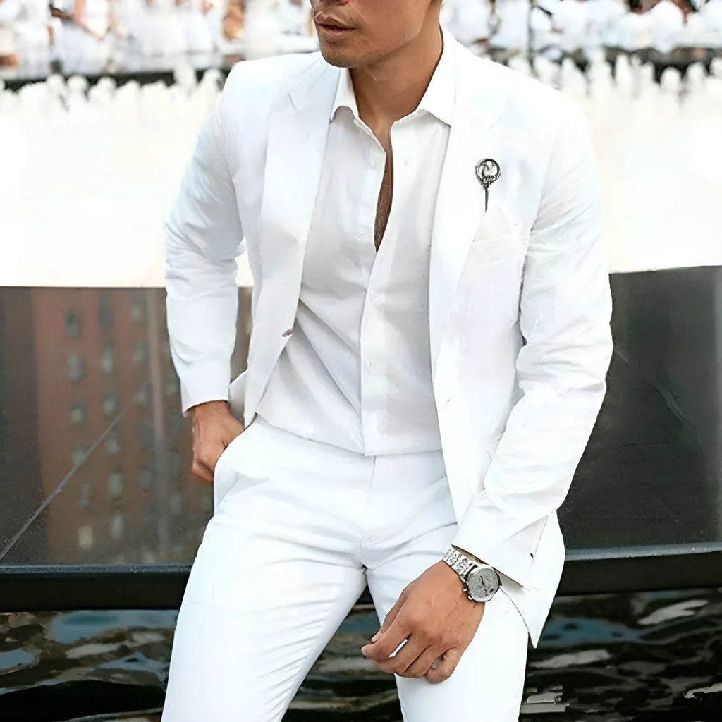 White men's slim fit two-piece suit jacket and trousers on a hanger.