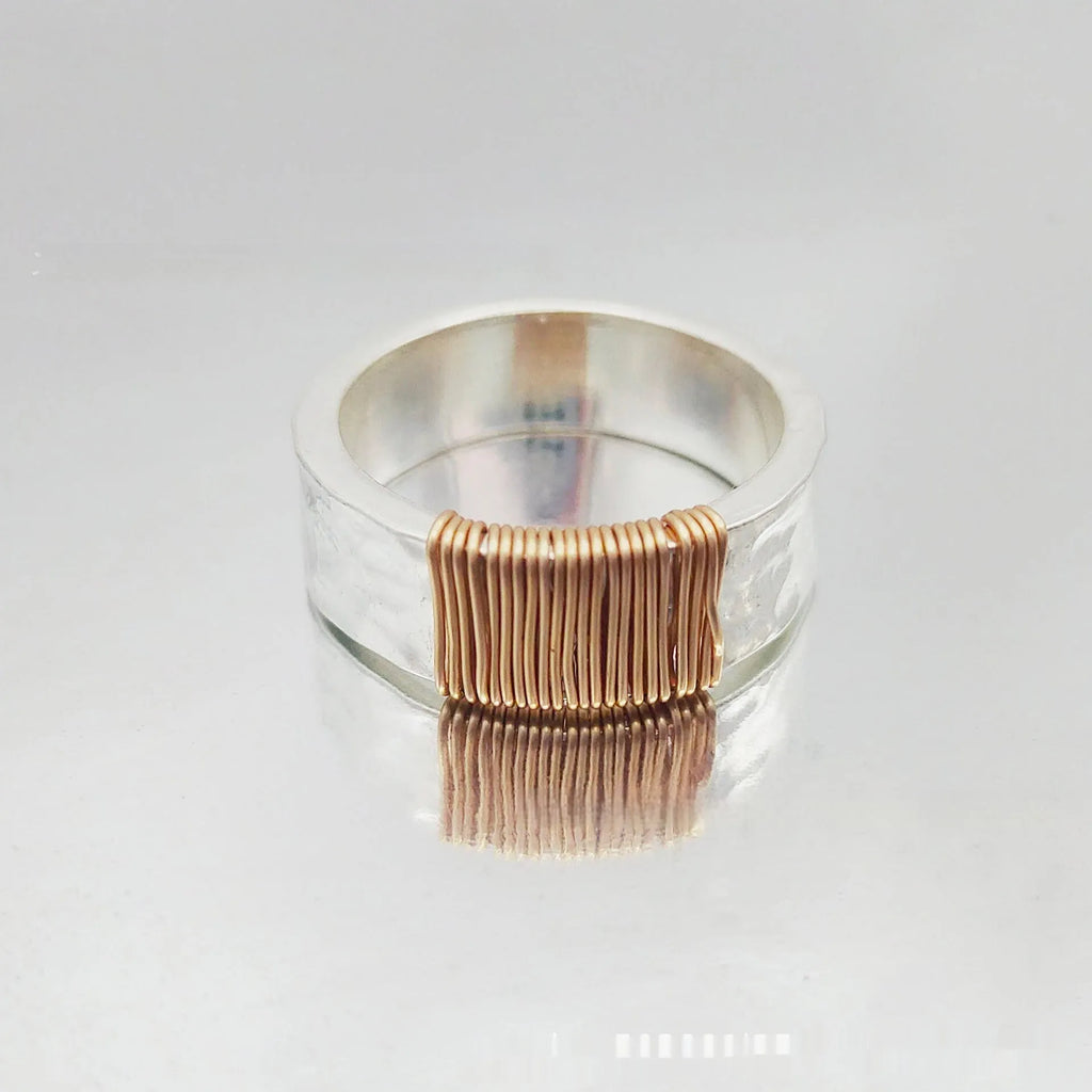 Geometric wide face copper bracelet ring with irregular coil design in silver gold finish.