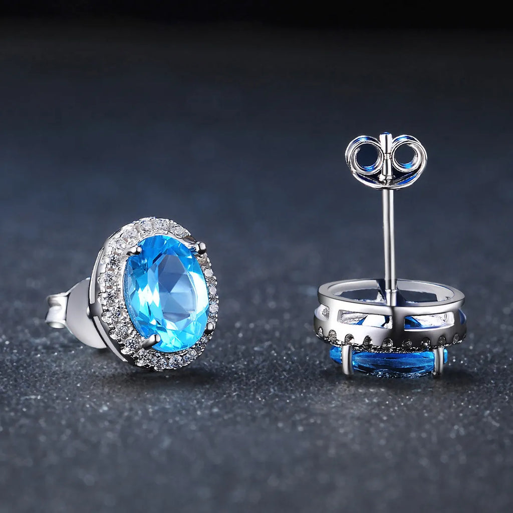 925 sterling silver jewellery set with blue topaz gemstones showing earrings, ring, pendant and necklace