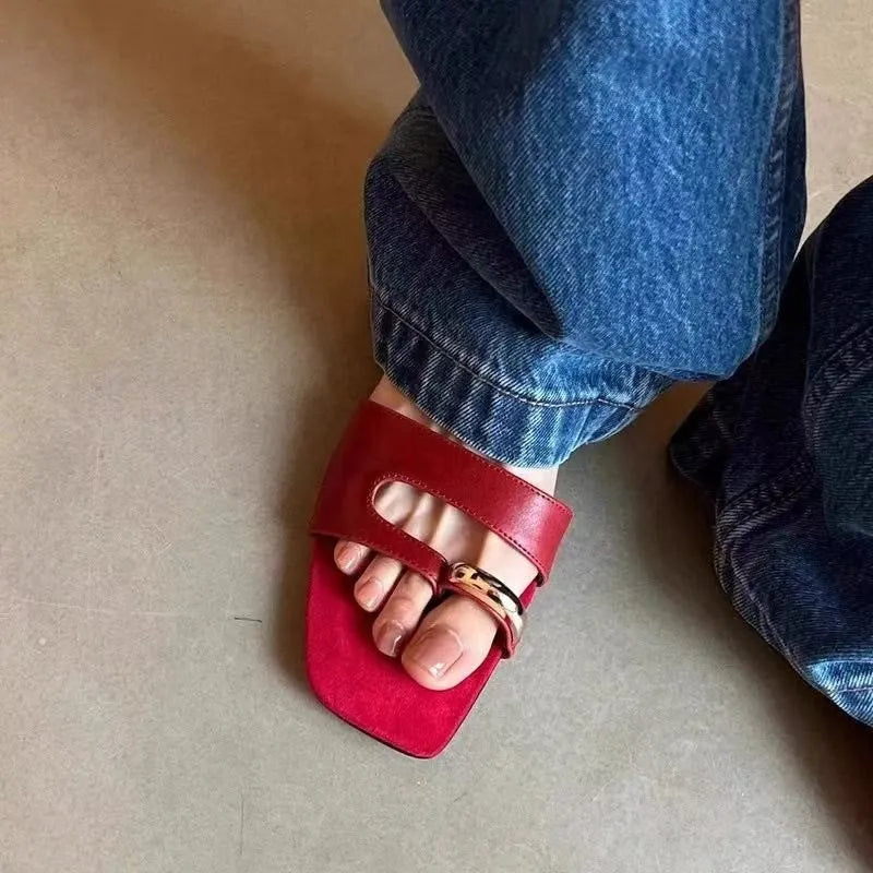 Leather upper outdoor slipper with square scaffolding toe and rubber sole in black, red, silver, and white.