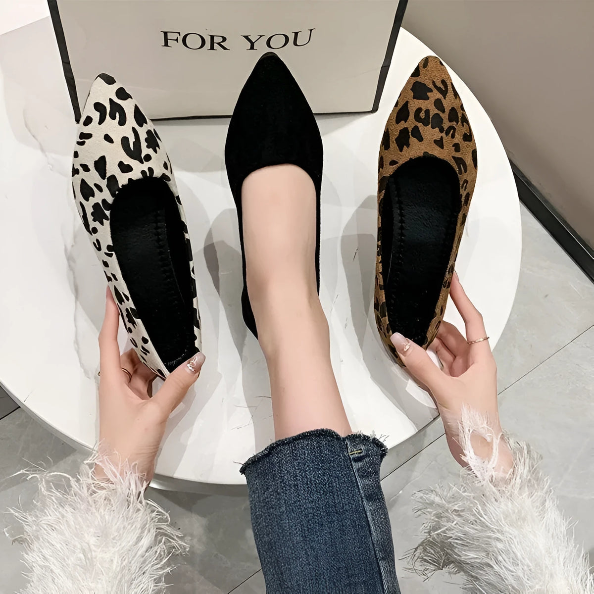 Women's leopard print flat pumps with pointed toe and low heel on a cotton cloth upper.