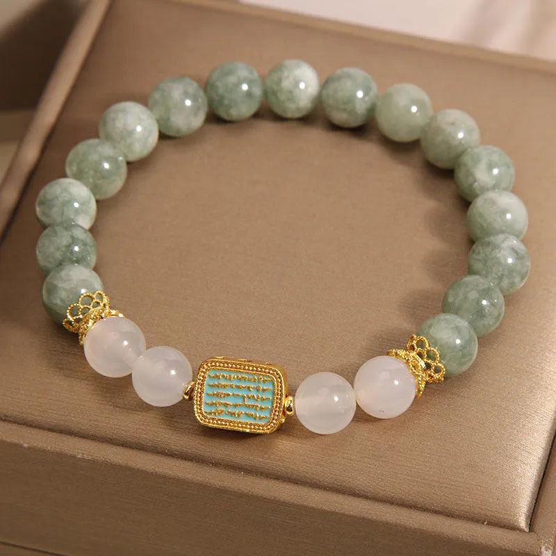 Oil green emerald crystal bracelet with five engraved Buddhist scripture beads on female wrist
