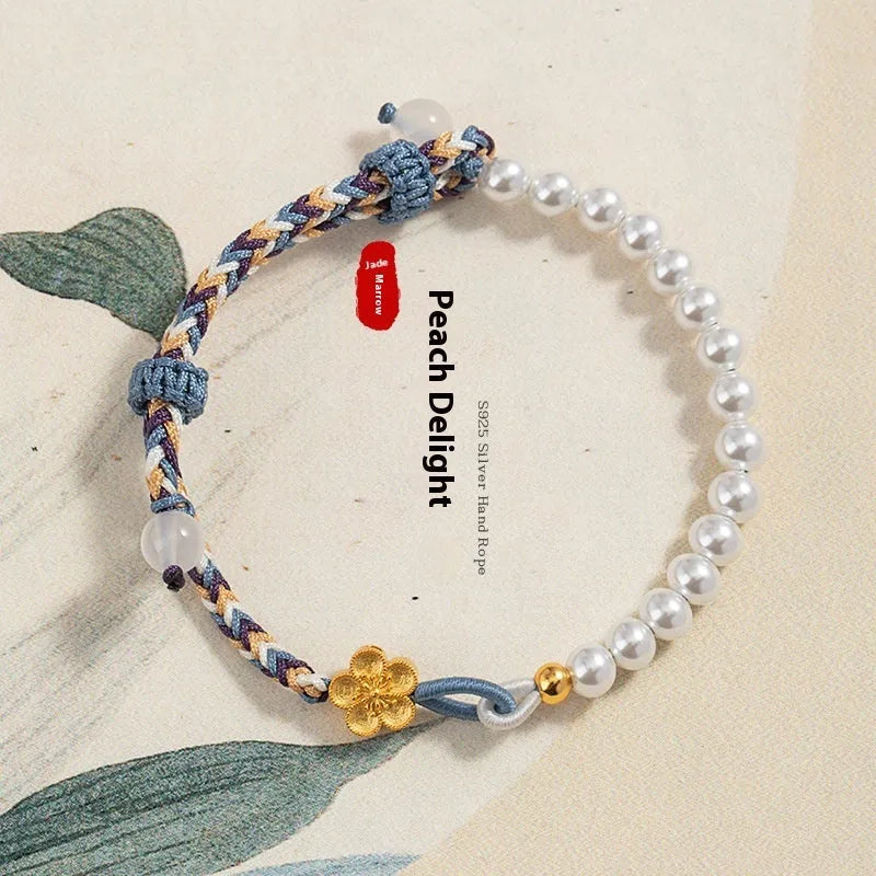 Peach-coloured adjustable cord bracelet with Chinese flower weaving and pearl details.