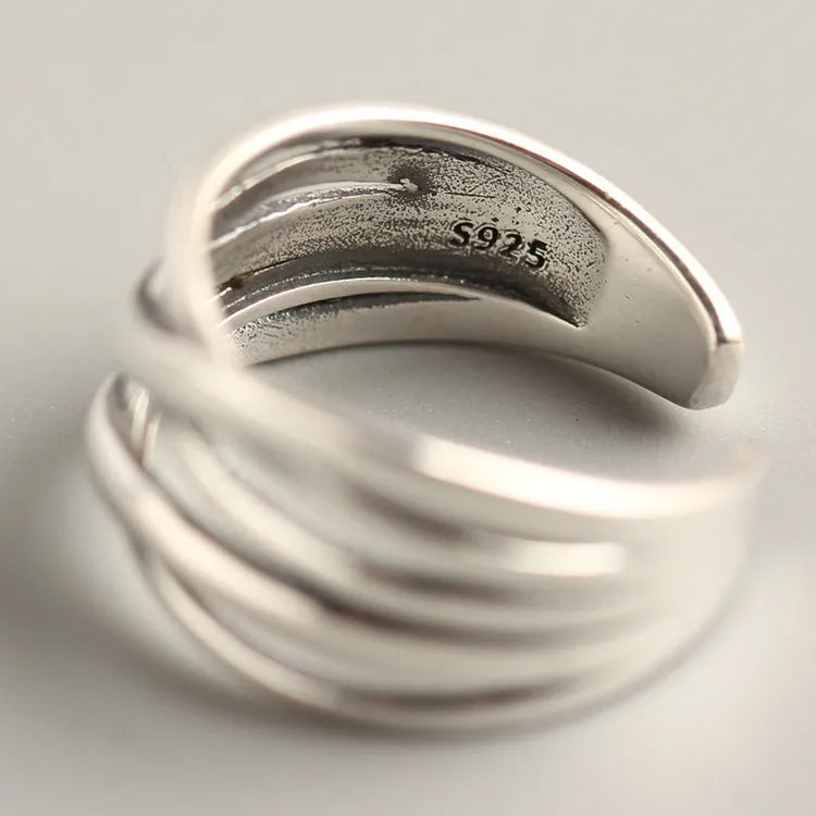 Close-up of a women's S925 sterling silver ring with a vintage weave pattern and retro silver finish.