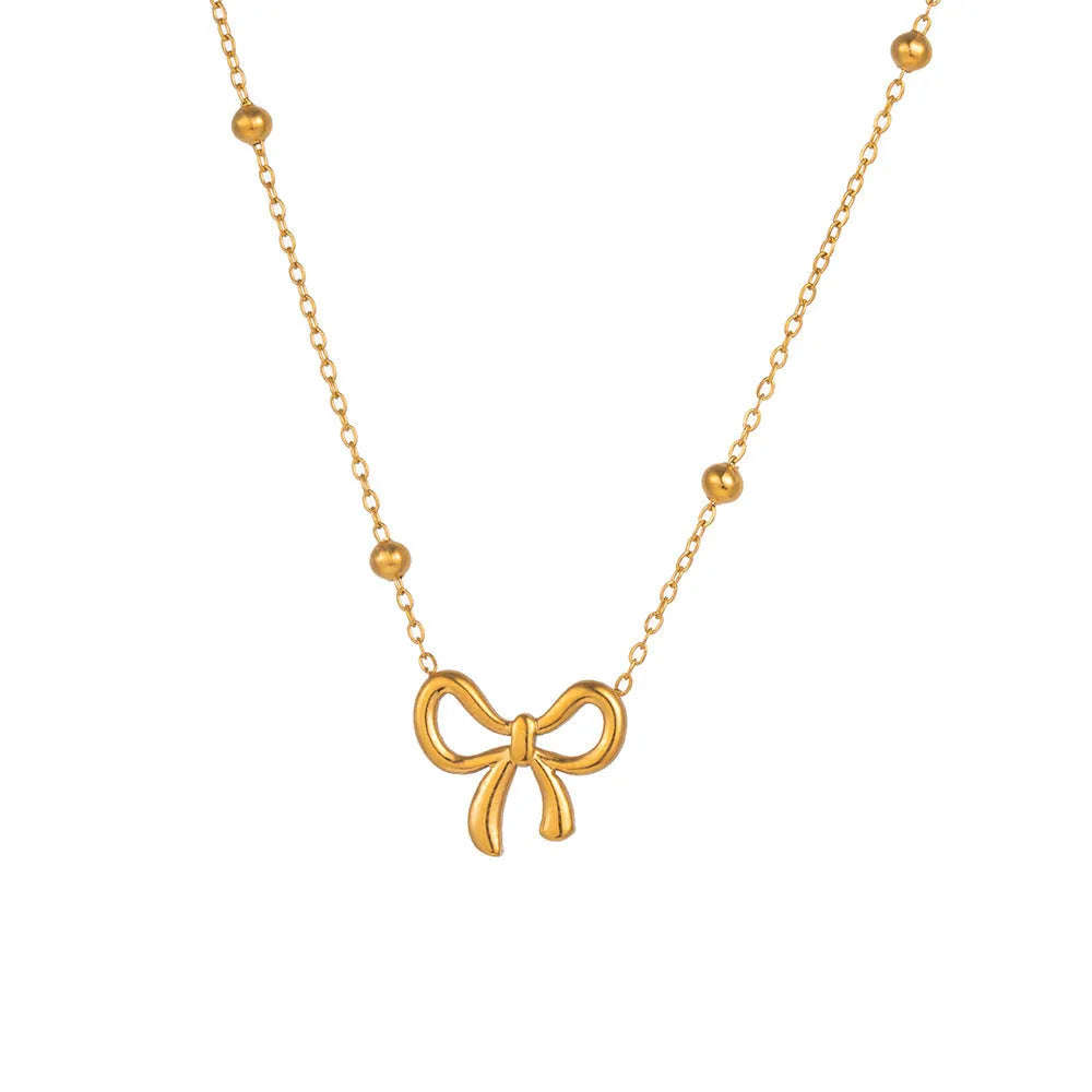 Gold electroplated bow necklace with adjustable cross chain for women