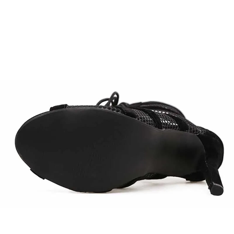 Black suede women's lace-up high heels with a high heel on a white background.