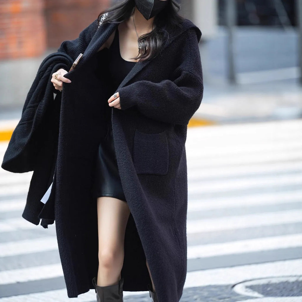 Women's long grey knitted cardigan with hood in trench coat style with regular long sleeves