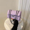 Small beige women's crossbody bag with diamond quilting and a single shoulder strap.