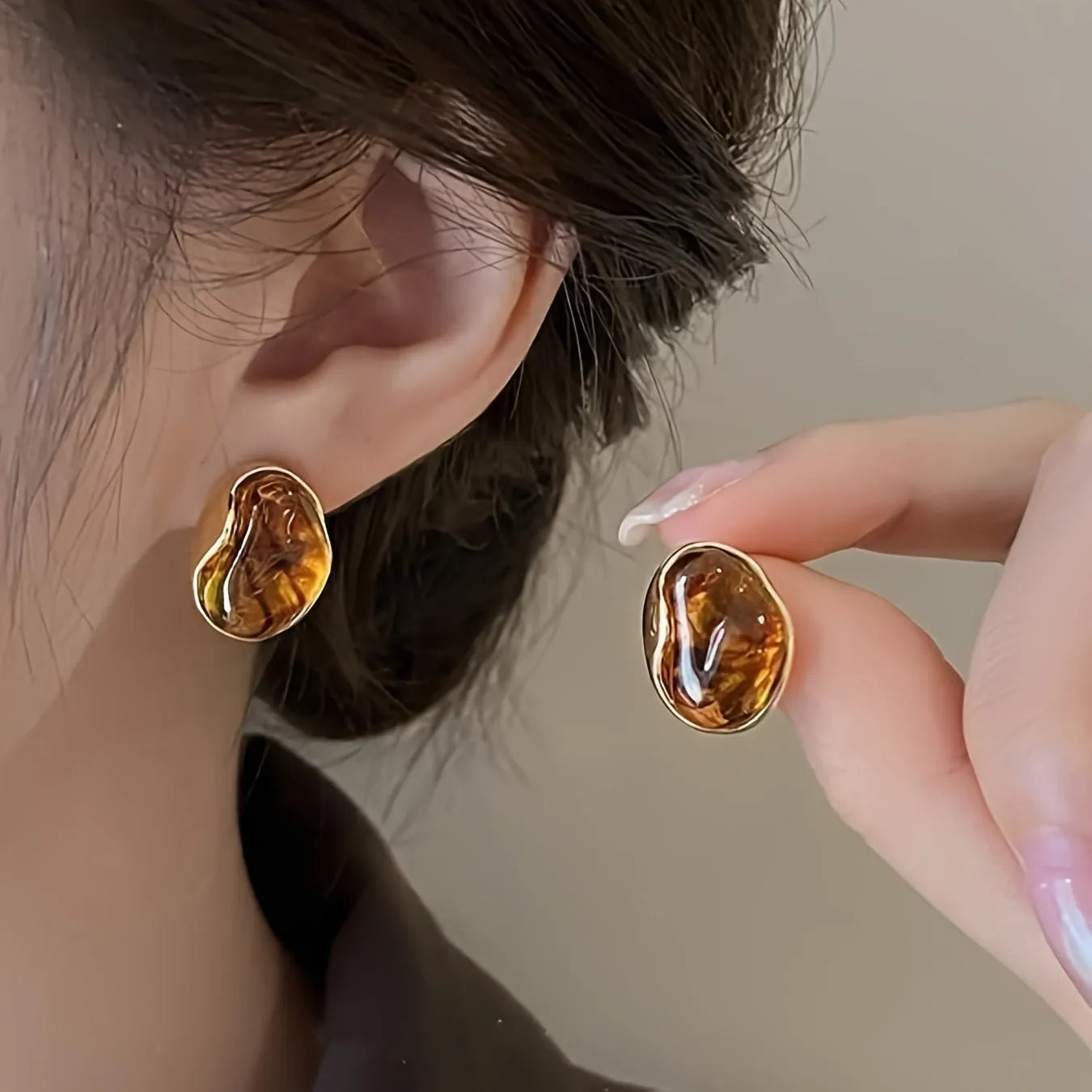 Three pairs of handmade holiday ear rings in geometric designs with tassel elements