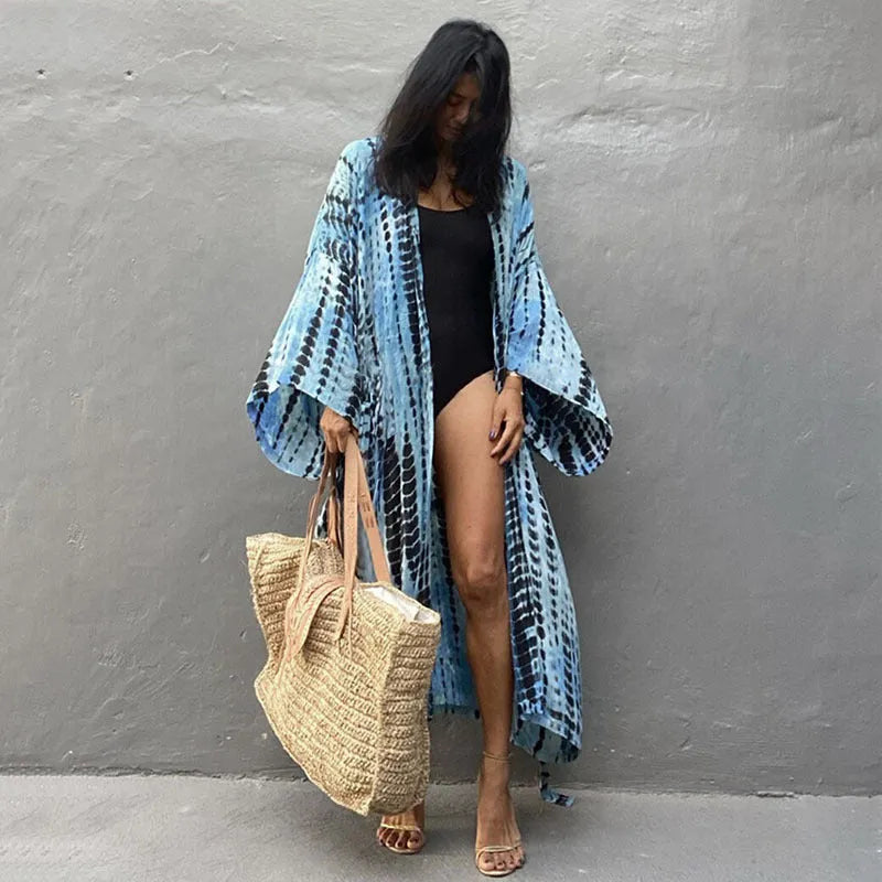 A printed, loose-fitting cotton beach cover-up blouse on a hanger, shown in a rust red colour from the DN0712 series.
