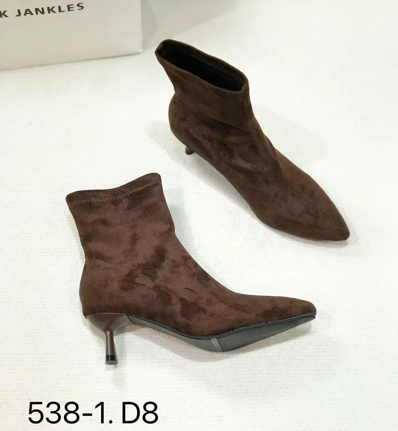 Black pointed toe women's ankle boots with a stiletto heel on a white background.