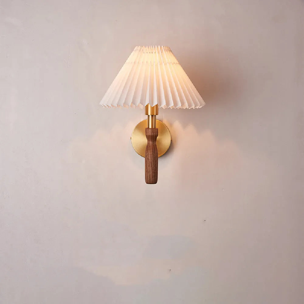 American retro-style wooden wall lamp with a fabric shade in a walnut finish on a bedroom wall.