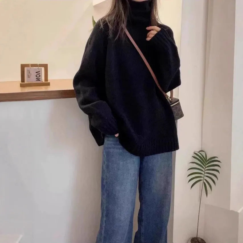 Red women's loose fit turtleneck sweater with a thick knit and curly pile collar on a hanger.