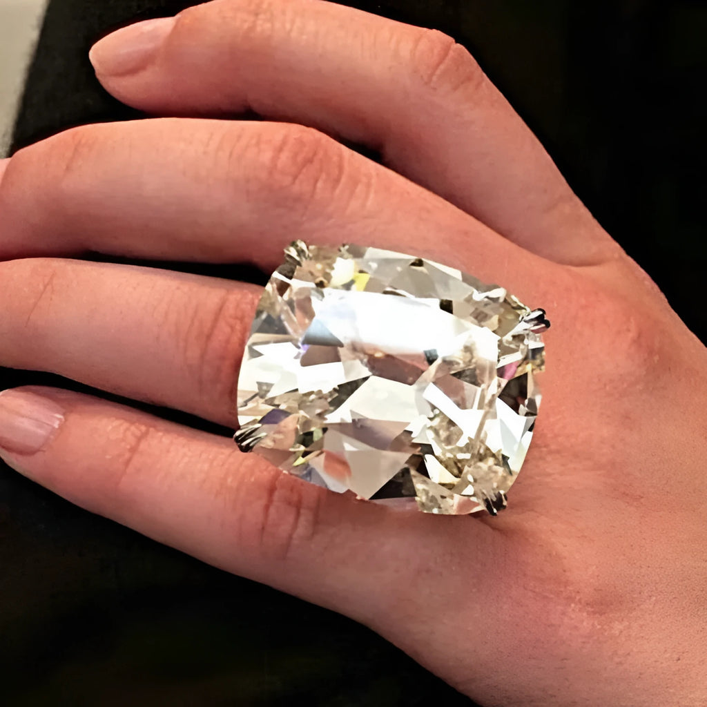 Women's white gold colour alloy ring with a simple inlaid square diamond on a geometric band.